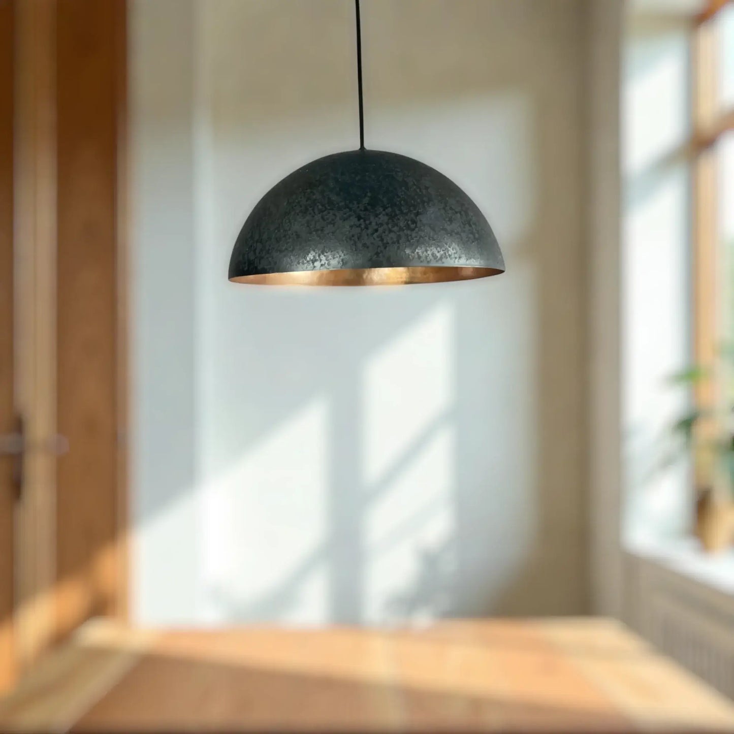 Copper Dome Lamp hanging elegantly in a bright room, casting soft light over a wooden table.