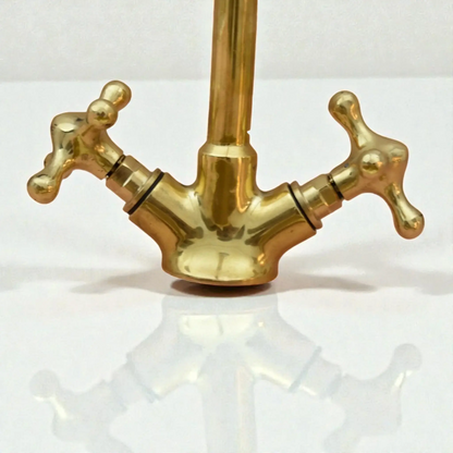Tall copper bathroom faucet with cross handles and a polished finish, ideal for modern or classic bathrooms.