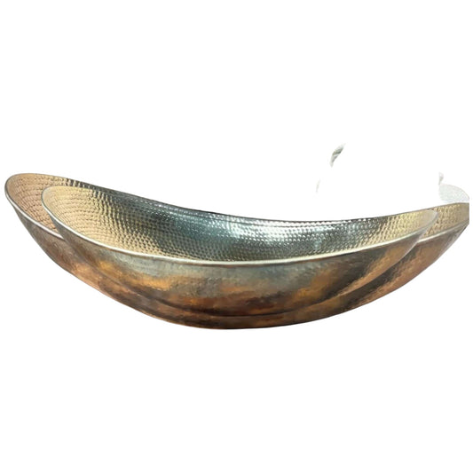 hammered brass bathroom vessel sink displayed with a modern faucet and fluffy towels in an elegant bathroom setting.