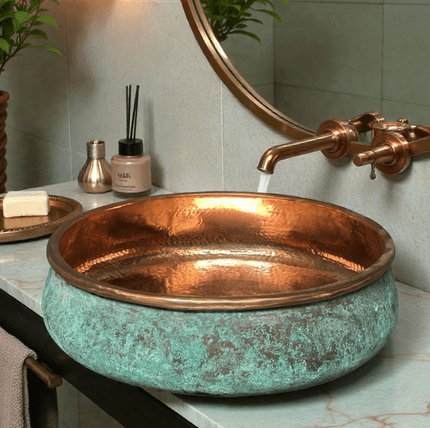 two tone green patina copper vessel sink in a stylish bathroom setting with hammered copper interior.