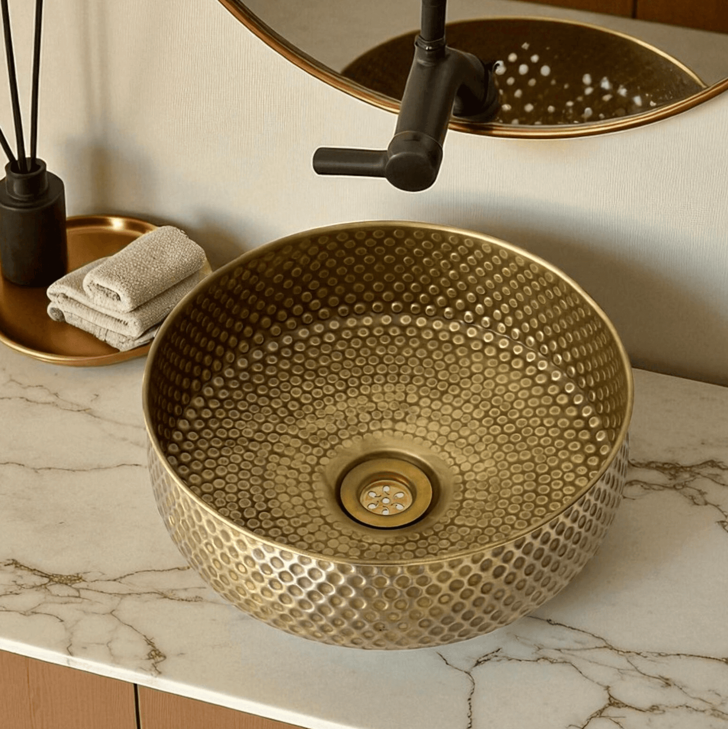 Elegant oxidized copper vessel sink featuring a unique textured design and polished drain.