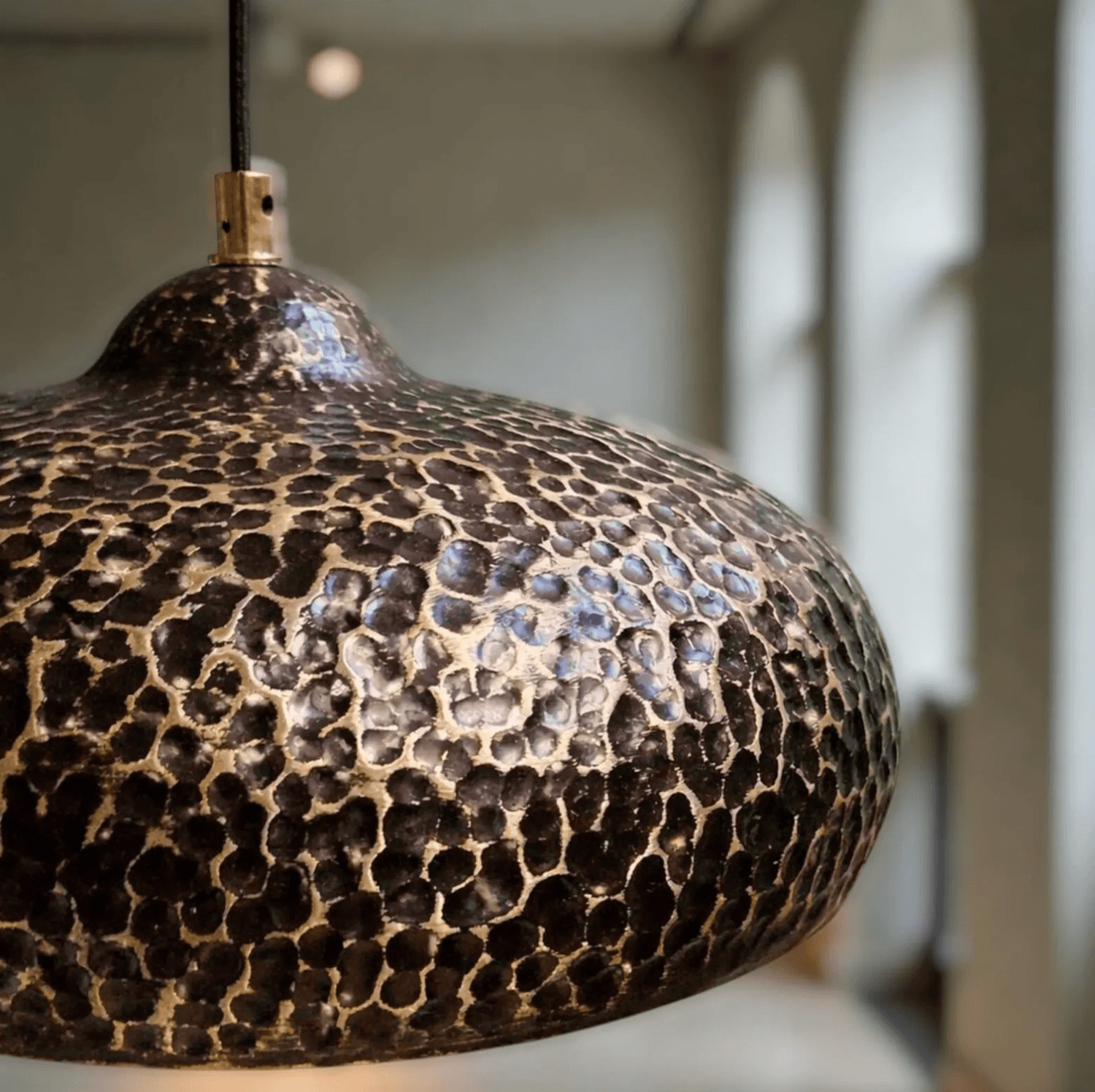 Hammered Dark Patina Copper UFO Pendant Light showcasing its unique textured design and warm tones.