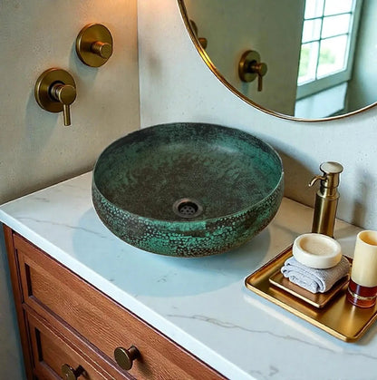 Coppera Studio green patina copper vessel sink with hammered texture and dark speckles. Round bowl design.