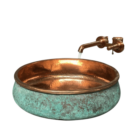 two tone green patina copper vessel sink in a stylish bathroom setting with hammered copper interior.