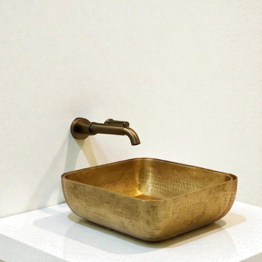 Luxury Hammered Brass Vessel Sink displayed in a modern bathroom with elegant decor and minimalist accessories.